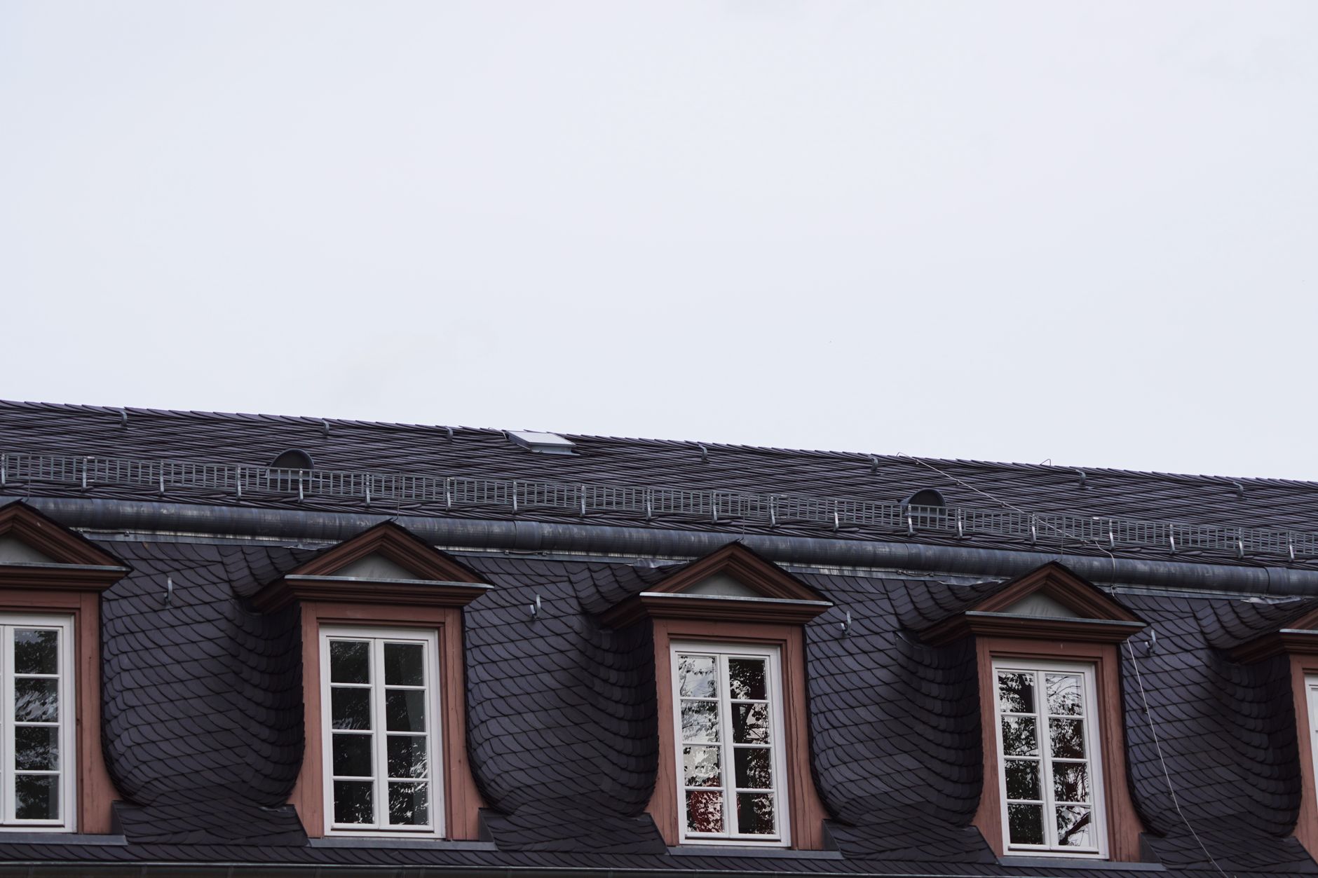 Close-up of natural Welsh slate roof tile materials showing copper nail fixings