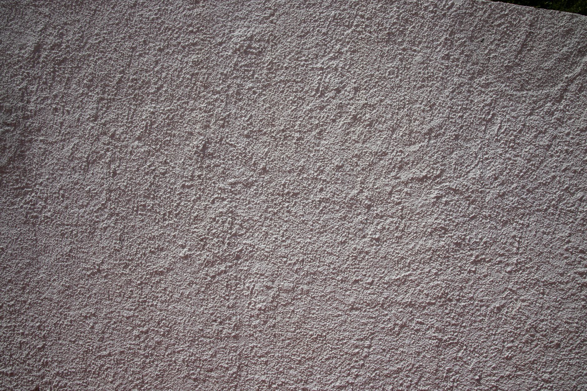 Close-up of reinforcing mesh being embedded in base coat render during external wall insulation installation